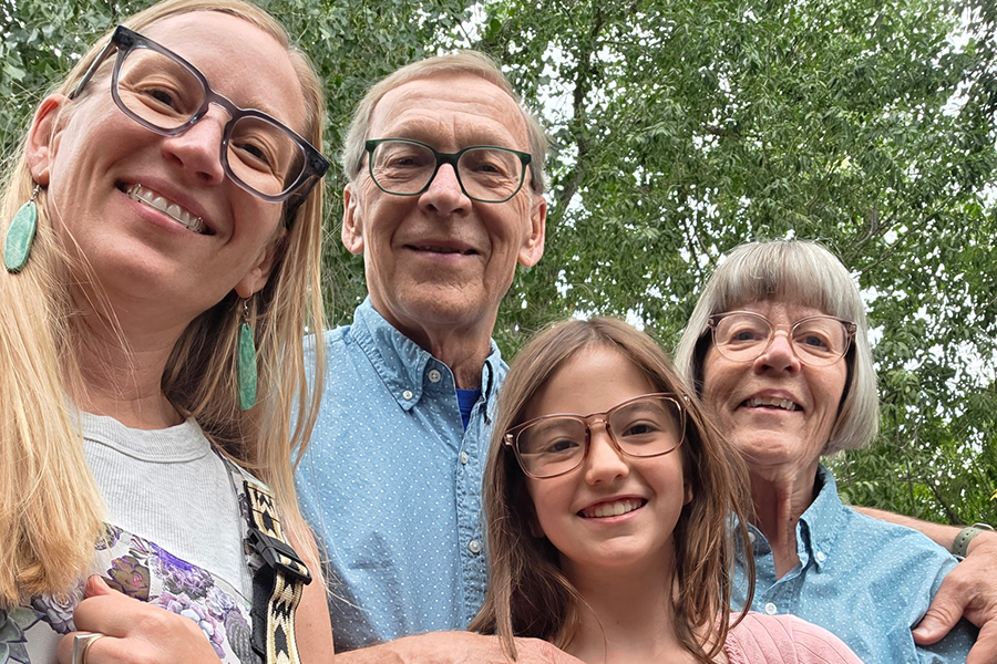 smiling, (woman, elderly couple, girl) poses outdoors.