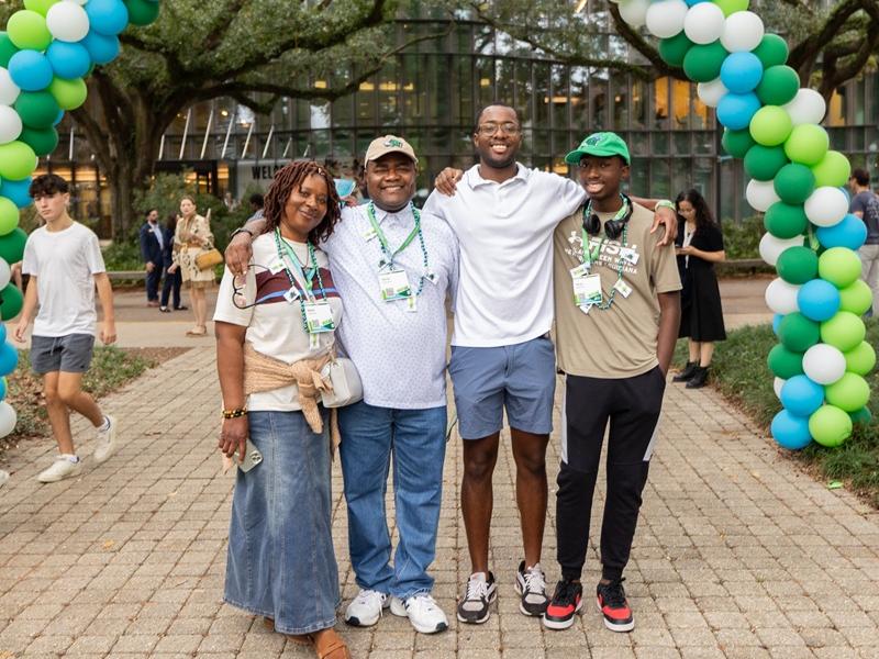 A family of four poses together at the Wave Weekend social event.